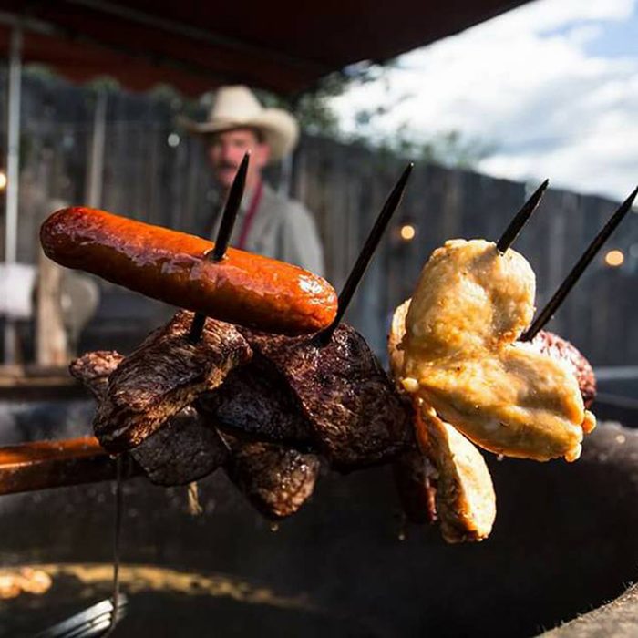 Cook meat skewered on a pitchfork