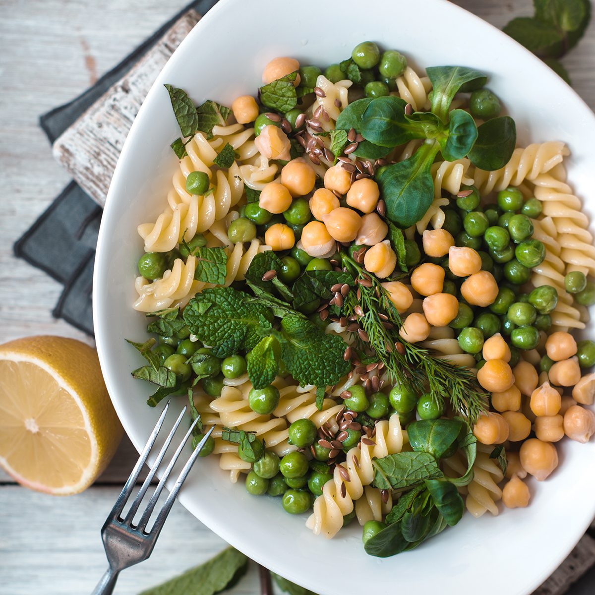 Salad with fusilli, chickpeas, grass in a white ceramic bow
