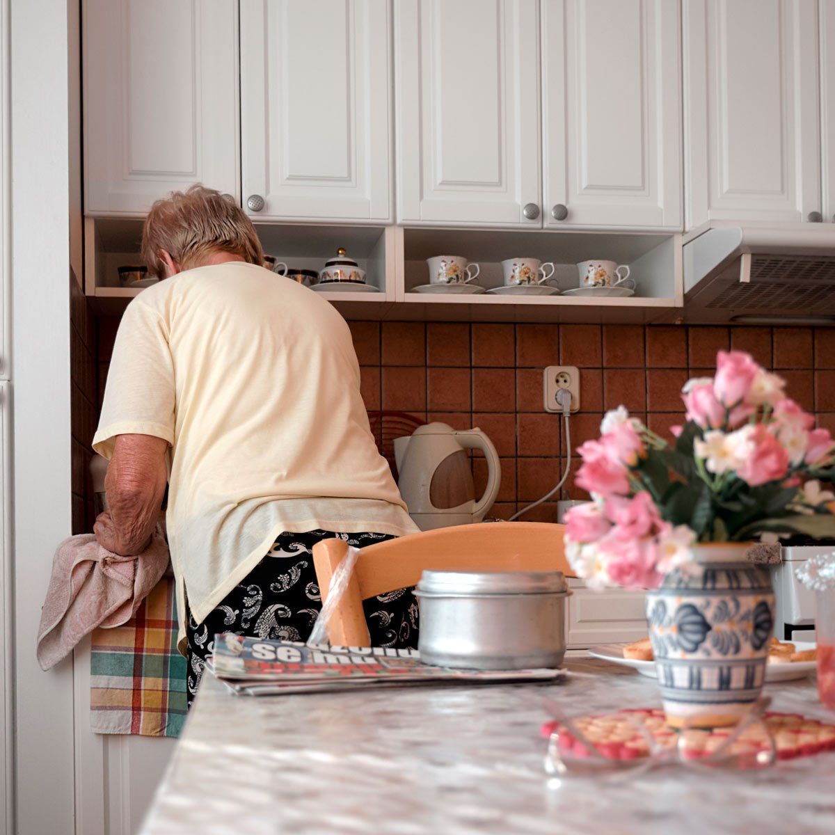 Person wiping down the counter in their kitchen