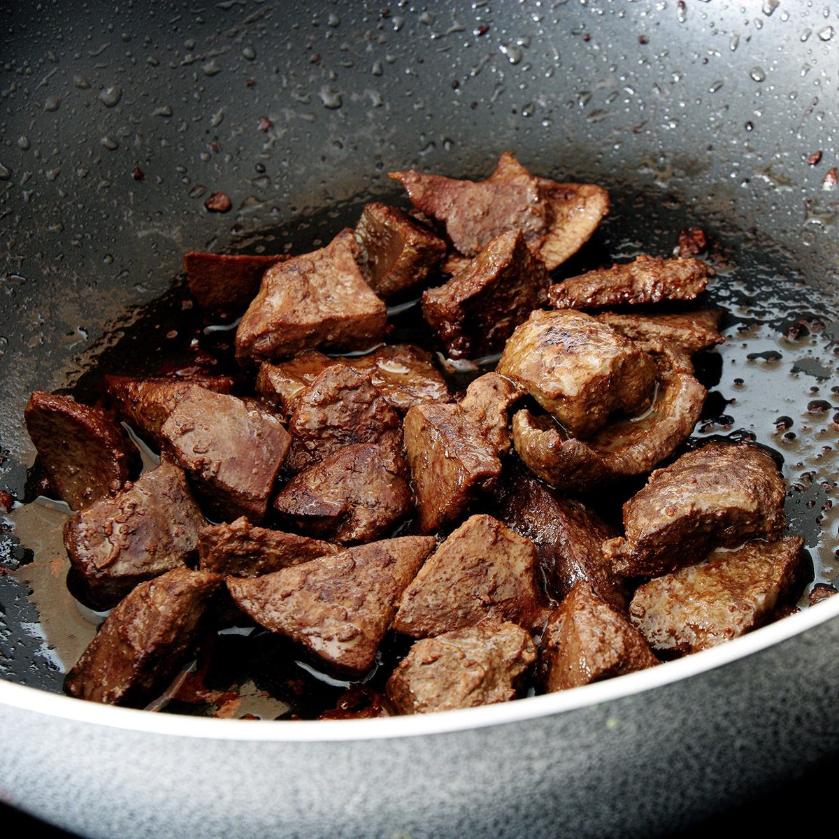 Pieces of fried beef liver in frying pan