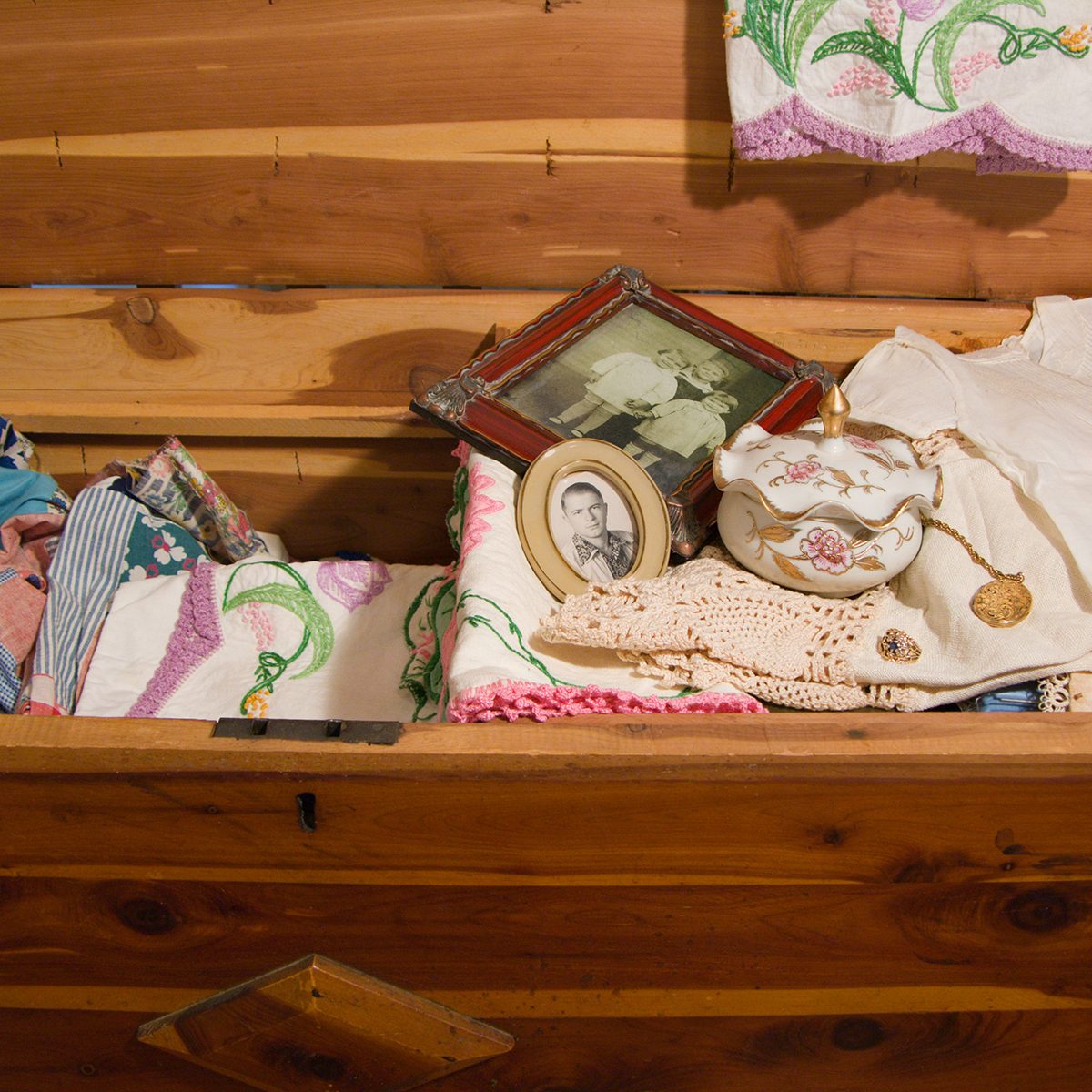 antique cedar chest with vintage linens, photographs and knicknacks