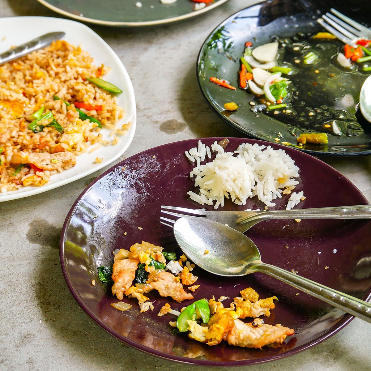 The leftover food on the restaurant table.
