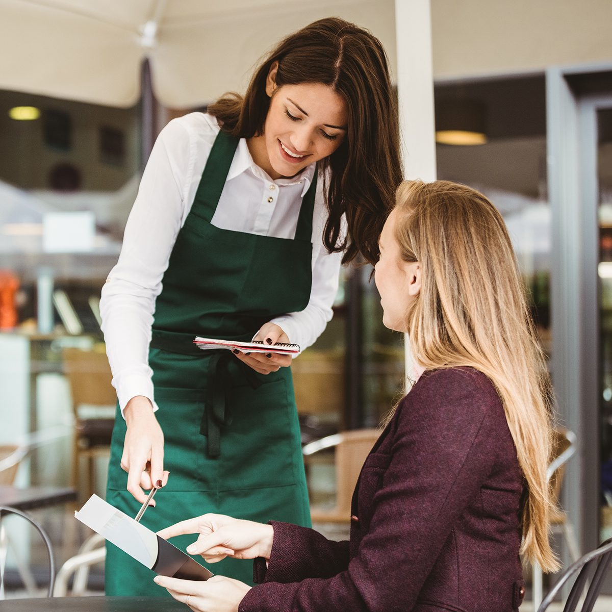 Smiling waitress taking an order in cafe; Shutterstock ID 388630609; Job (TFH, TOH, RD, BNB, CWM, CM): Taste of Home