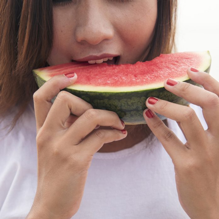 Young woman eating watermelon.