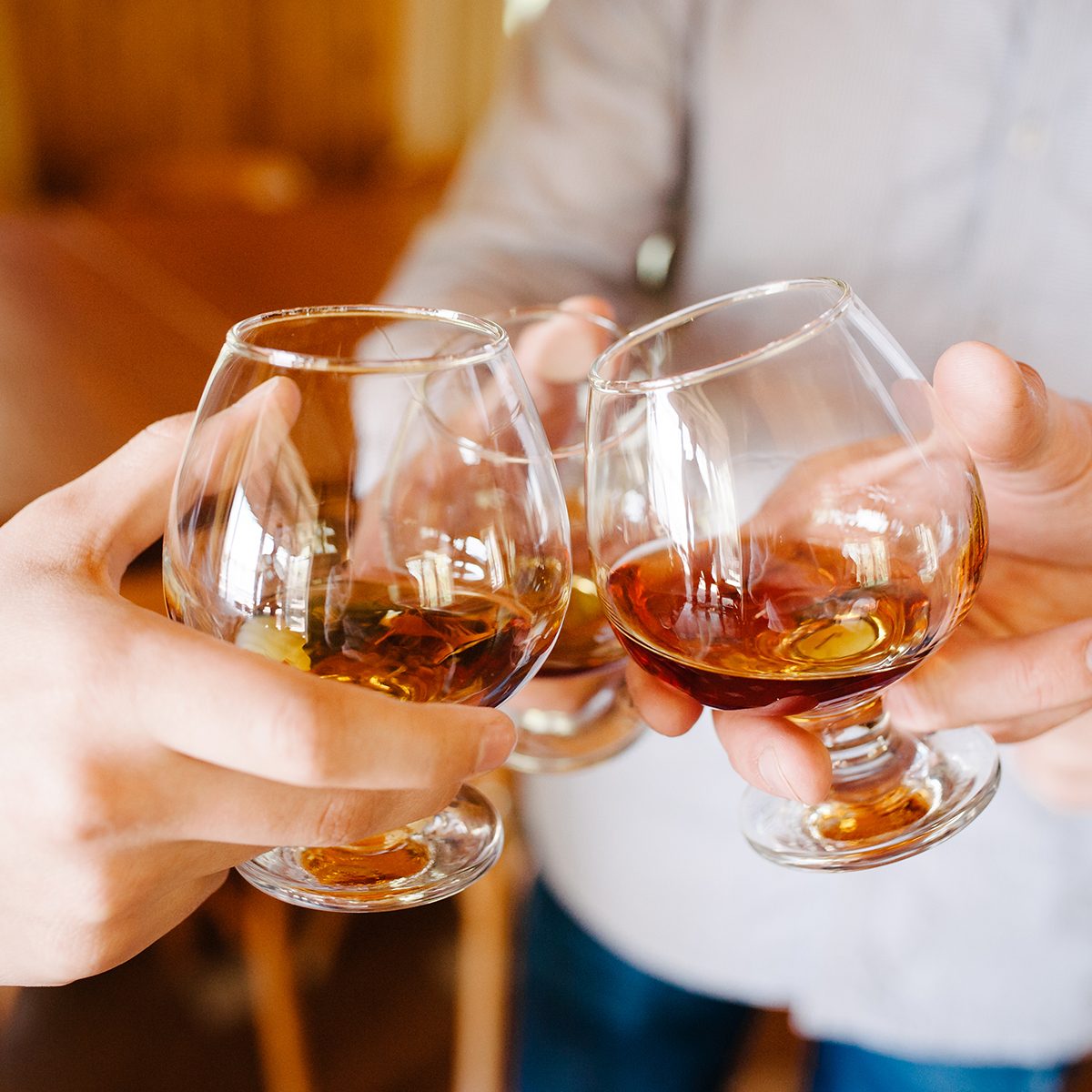 Group of friends a toast to the cheers of cognac or brandy