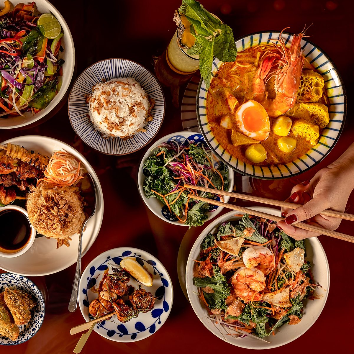Thai food selection, top down view of multiple dishes.