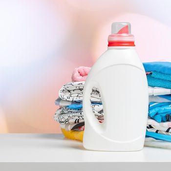 Clean laundry and liquid washing detergent front view