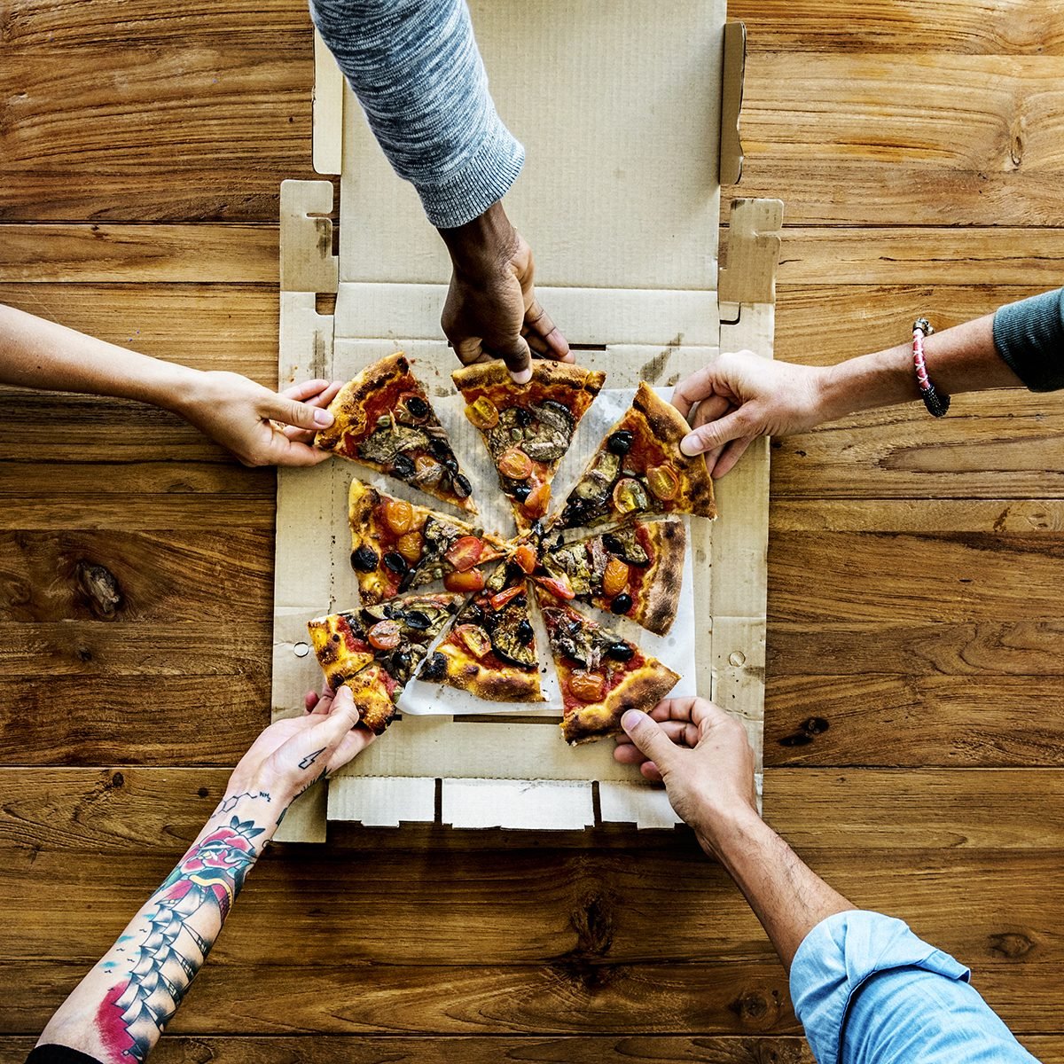 People Hands Grabbing Pizza from Delivery Box