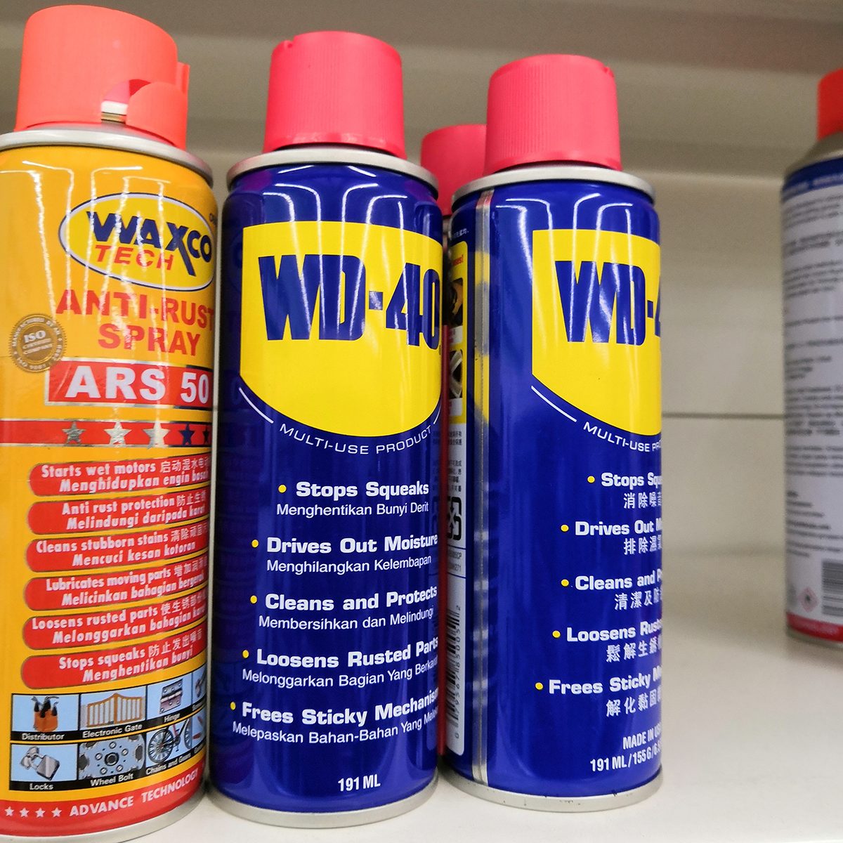 A bottles WD 40 lubes brand display at supermarket shelf.