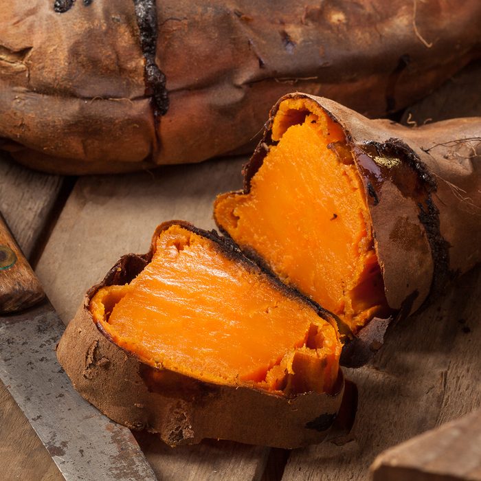 Oven baked sweet potatoes on vintage wood.
