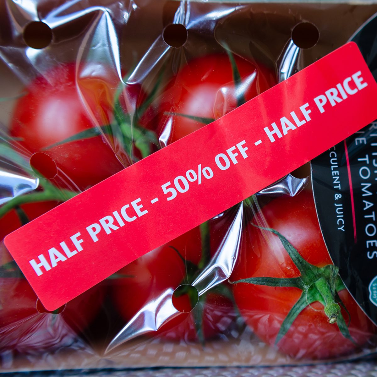 Stone, Staffordshire / UK - July 1 2019: Pack of British Regal Vine Tomatoes with discount label from ALDI supermarket. Short dated vegetables on clearance are with label: 