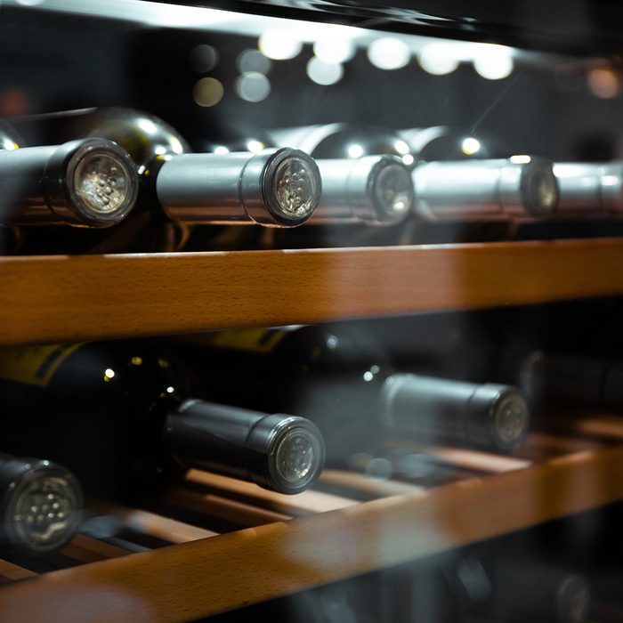 Storing bottles of wine in fridge. Alcoholic card in restaurant.