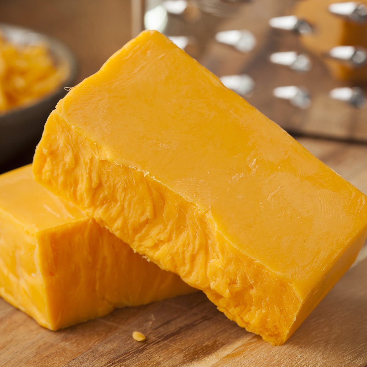 Organic Sharp Cheddar Cheese on a Cutting Board