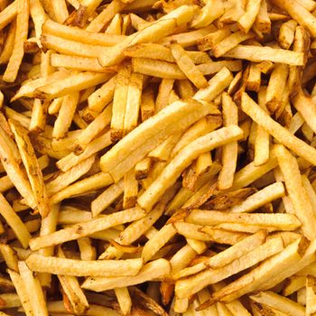 Background of cooked french fries just pulled from the deep fryer.