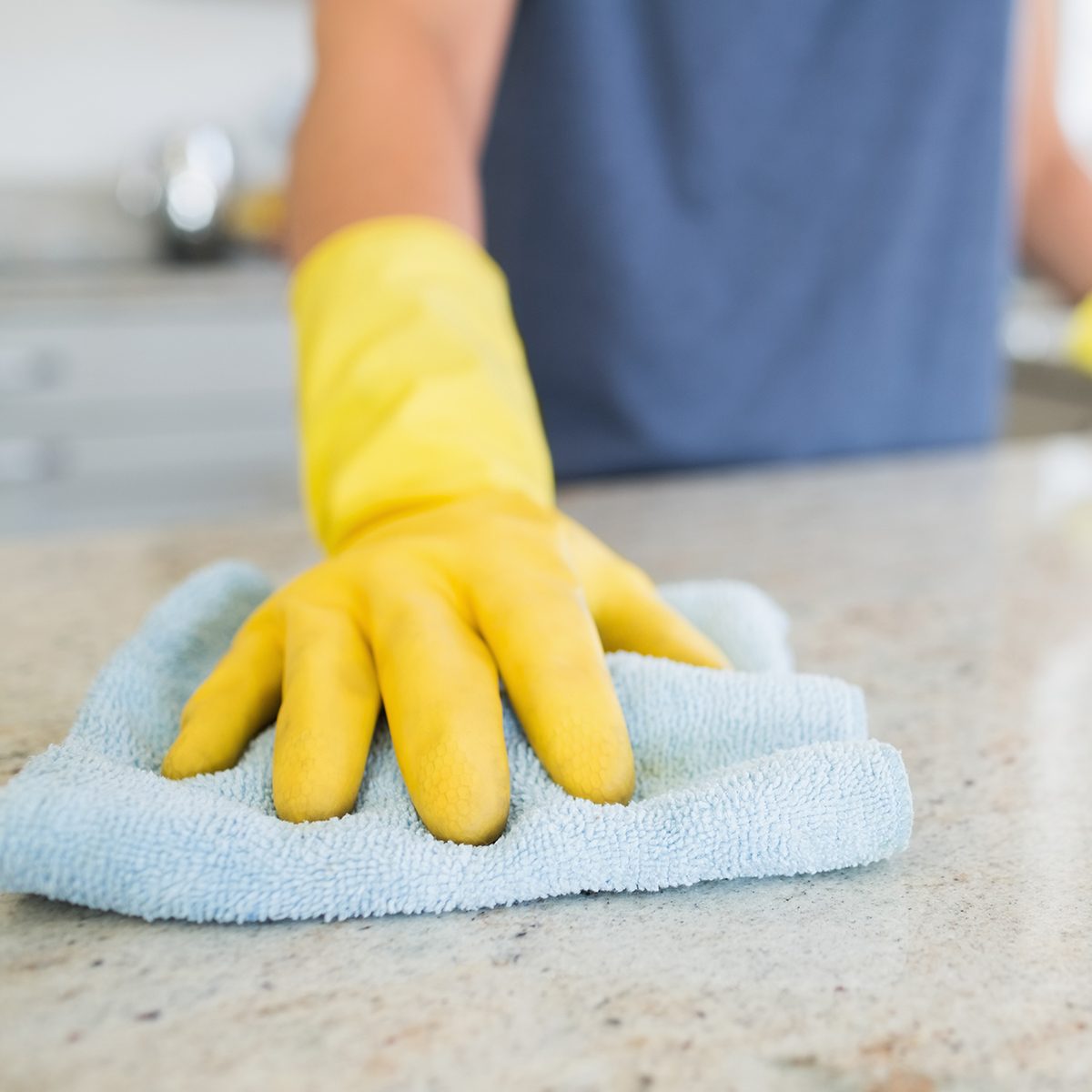 Woman cleaning the counter in the kitchen