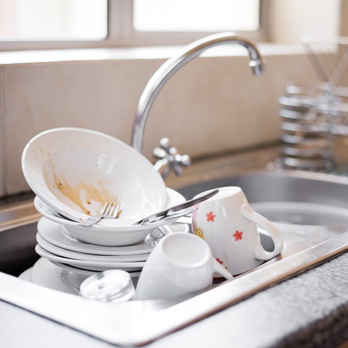 Shot of kitchen sink full of dirty dishes