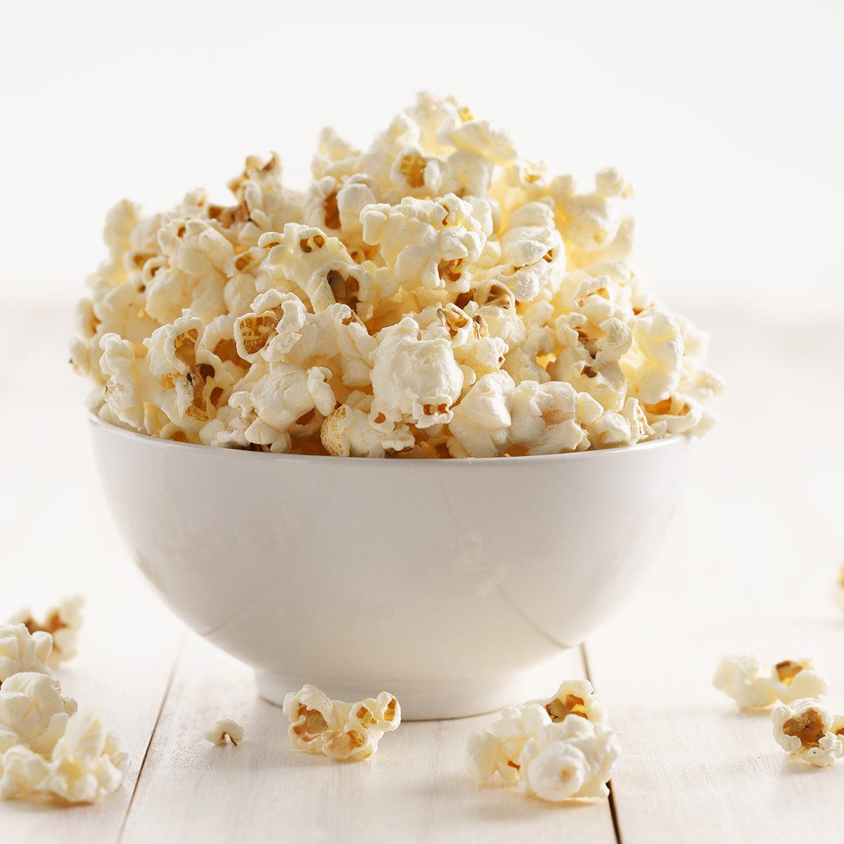 popcorn with caramel in a white porcelain bowl