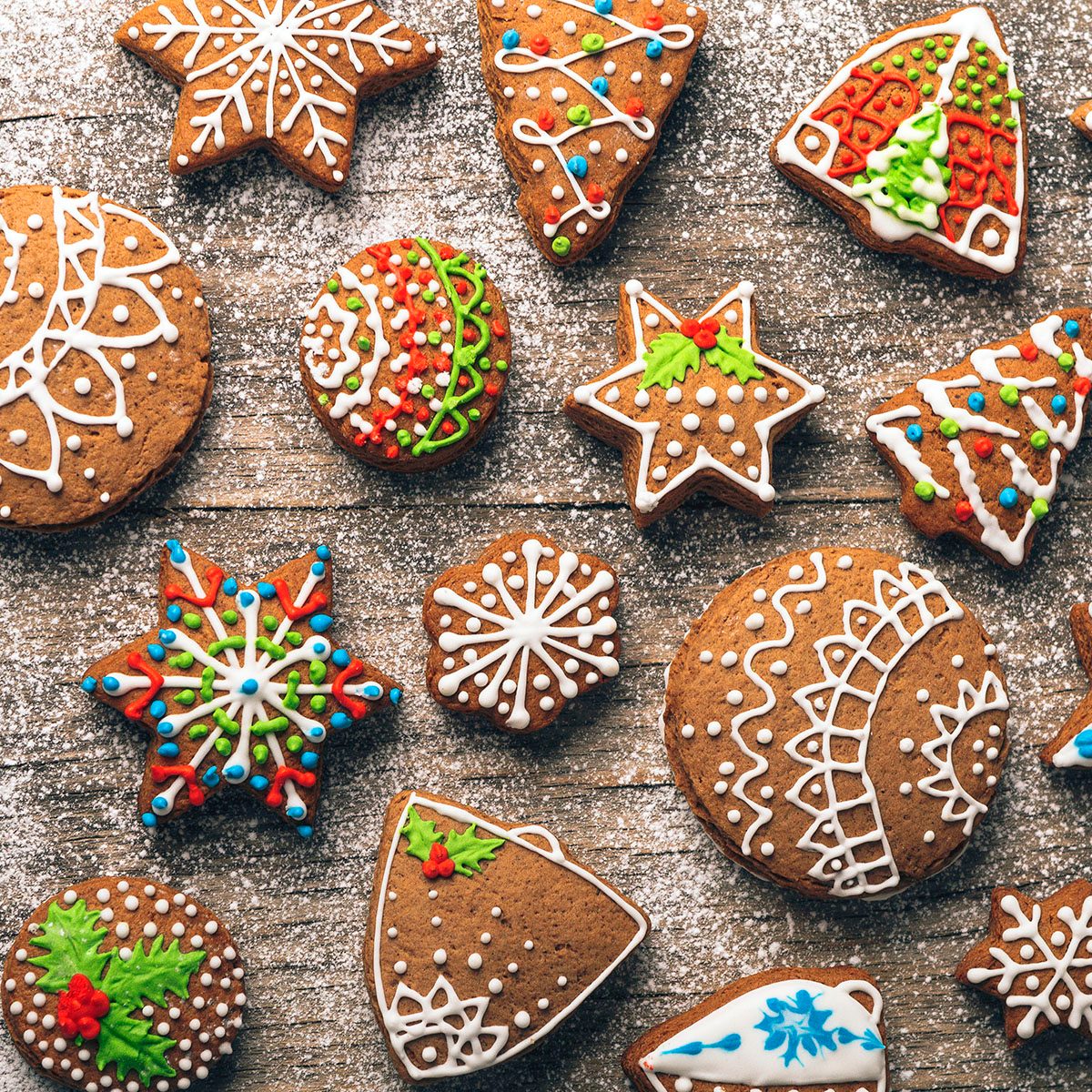Christmas gingerbread cookies on wooden table with sugar