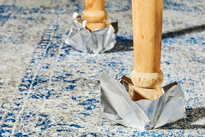 moving heavy furniture by putting foil on the legs