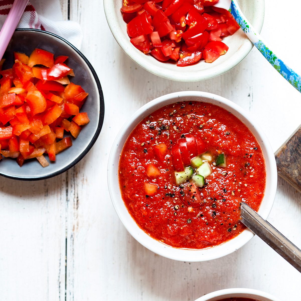 Bowl of Gazpacho with cucumber and bell pepper topping