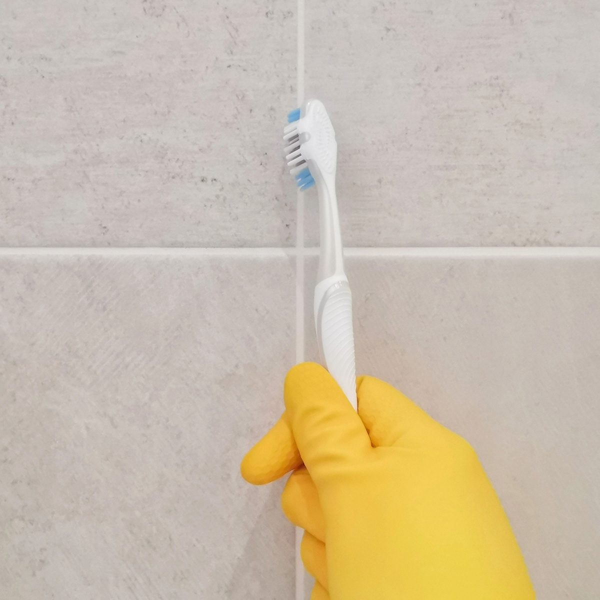 Cleaning bathroom titles and grout.