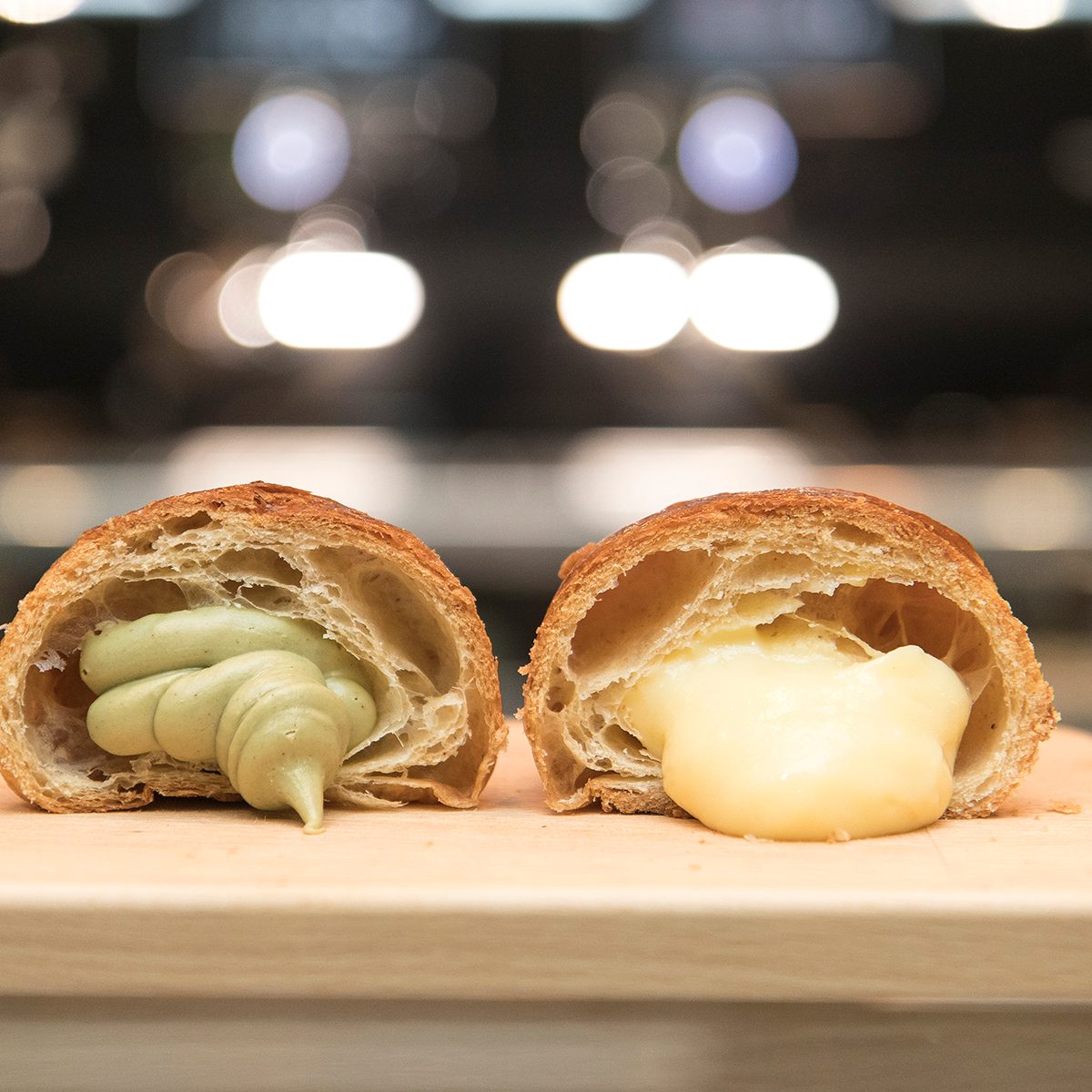 Close up on industrial croissants on a bar table top.