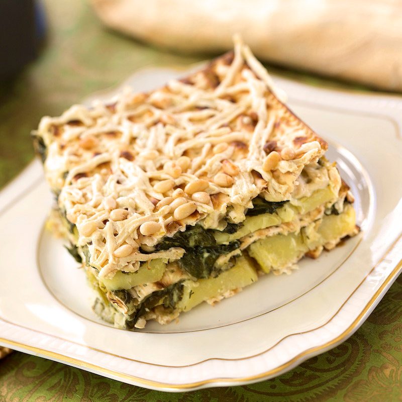 A piece of spinach matzo mina on a plate.