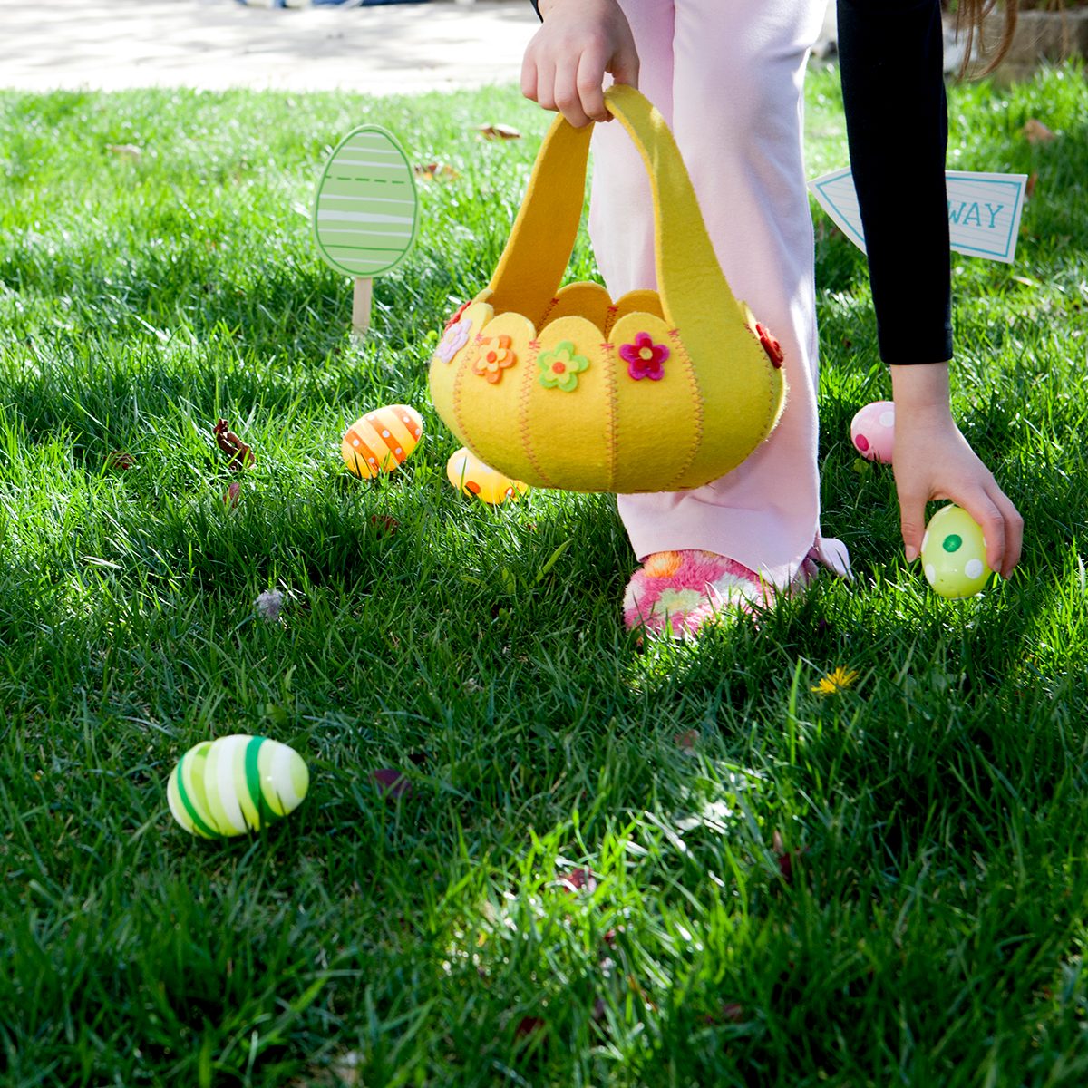 easter egg hunt ideas Child picking up eggs on easter.