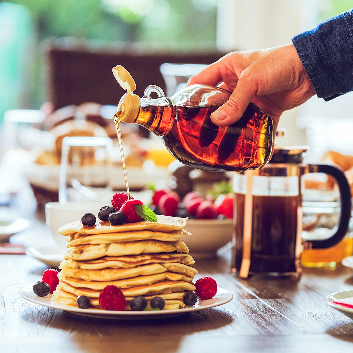 Stack of Pancakes with Maple Syrup, Berries and Fresh Coffee for breakfastStack of Pancakes with Maple Syrup, Berries and Fresh Coffee for breakfast