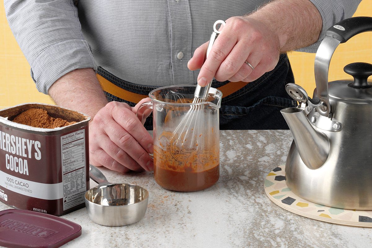 Combining Cocoa Into Water. Cocoa On Side