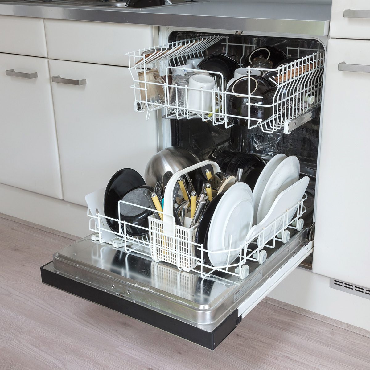 Open Dishwasher With Clean Plates, Cups And Dishes