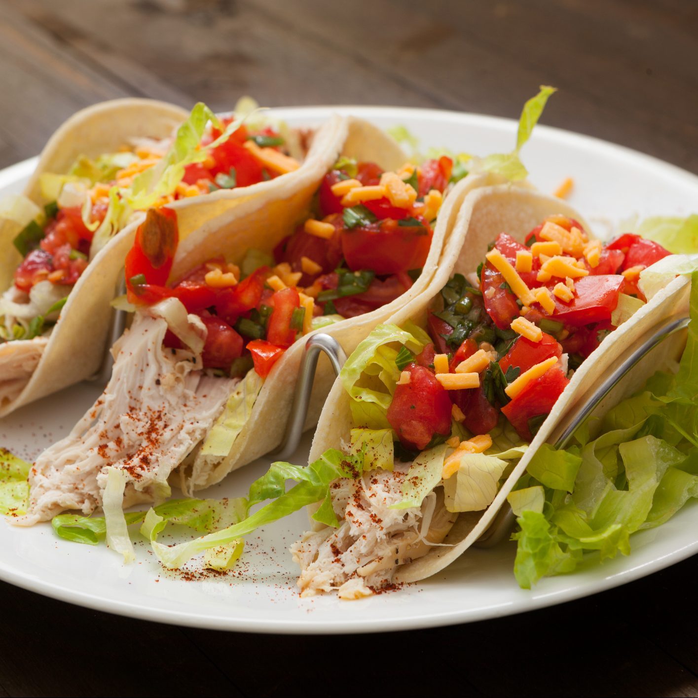 Three Chicken Tacos on a white plate