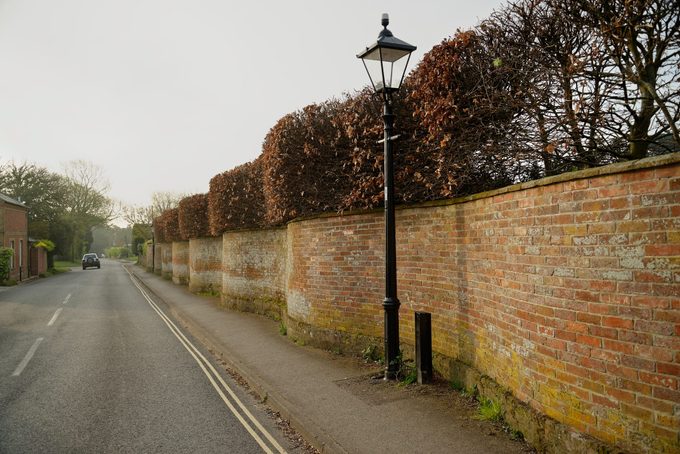 Curvy wavy wall made from red bricks along a roadway in the united kingdom