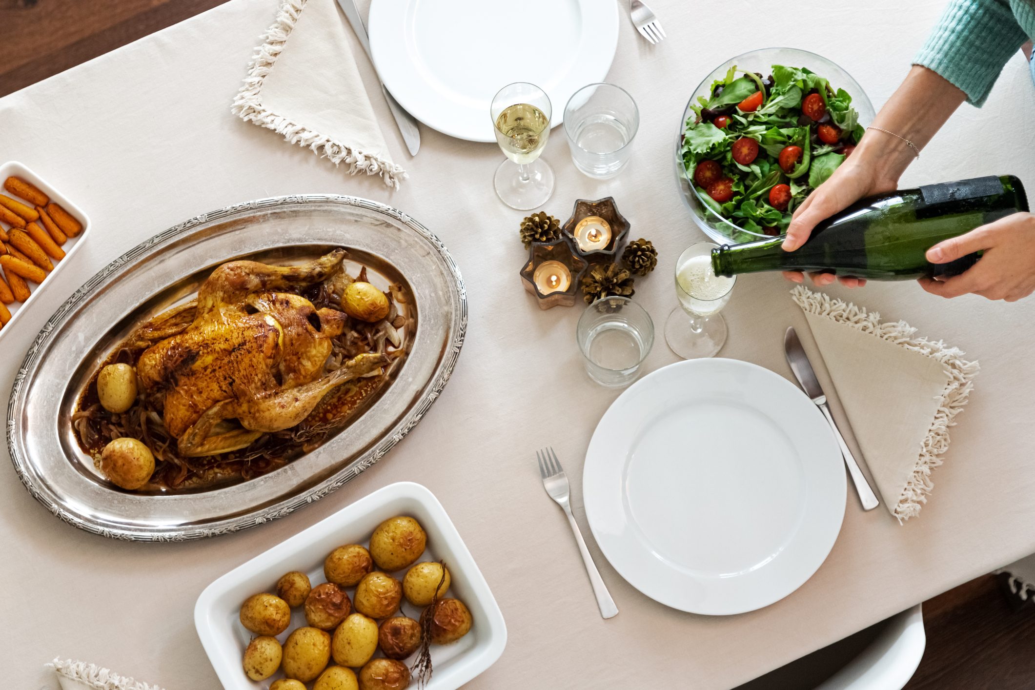 Top view of festive holiday dinner with roasted chicken and champagne