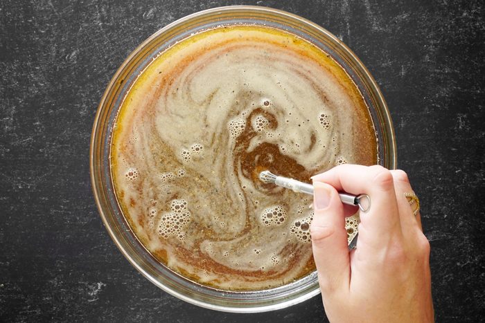 mixing marinade for turkey in a clear glass bowl, top view
