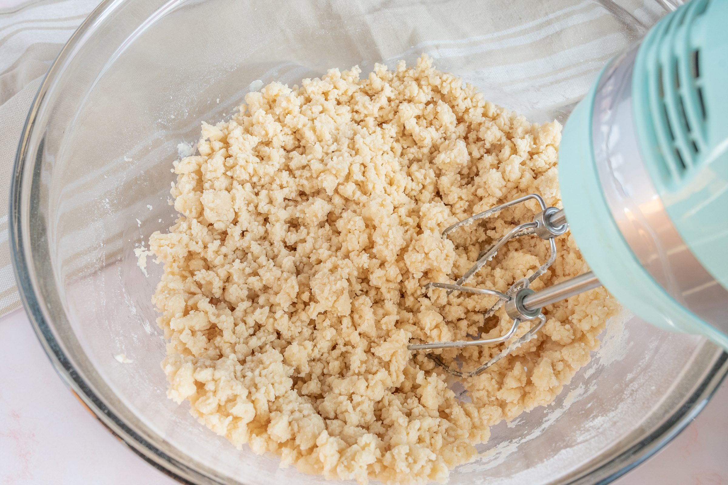 adding flour to butter and sugar for 3 ingredient sugar cookies