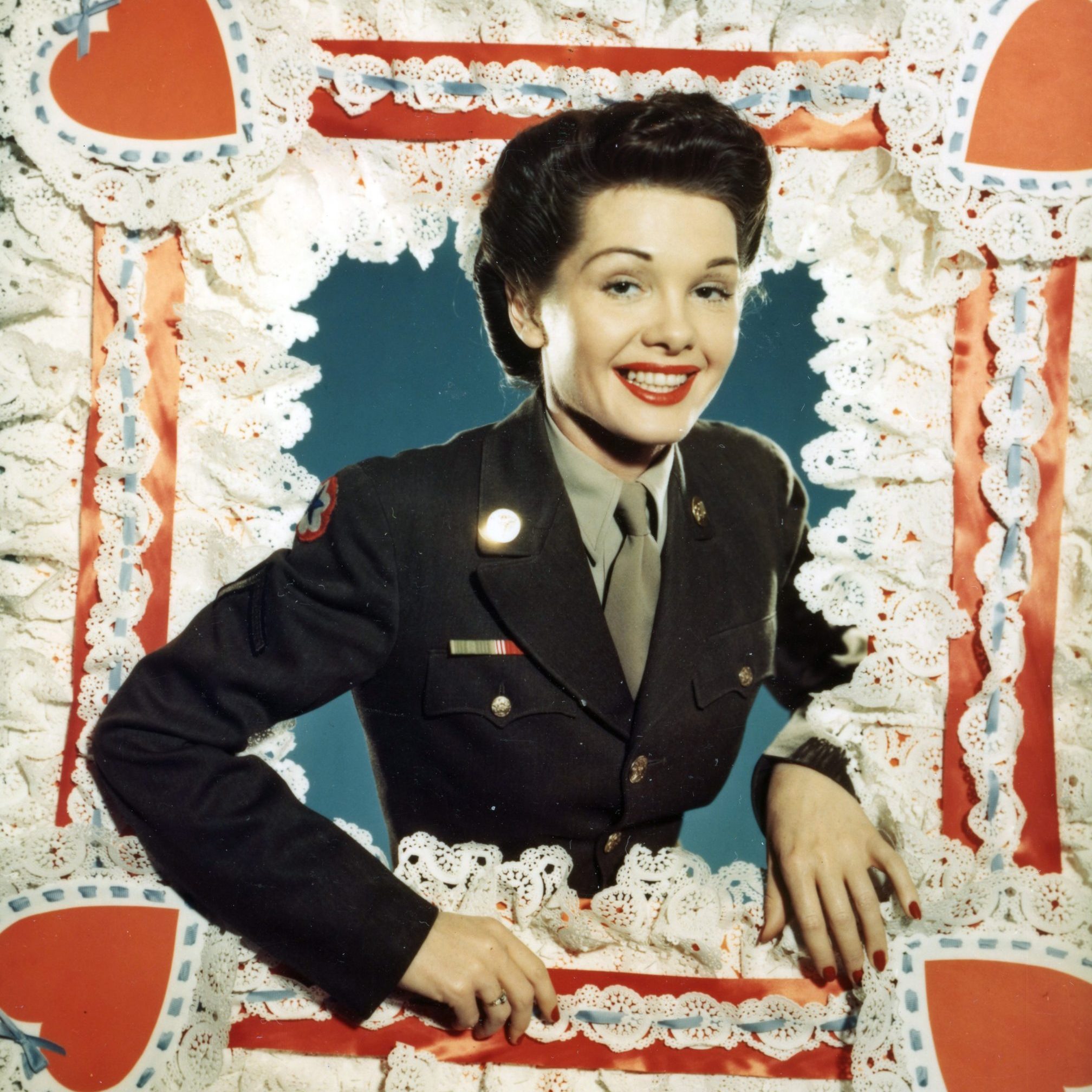 Portrait of Pfc (private first class) Dorothy LeRoy (of Atlanta, Georgia) as she poses in the oversized frame of a Valentine