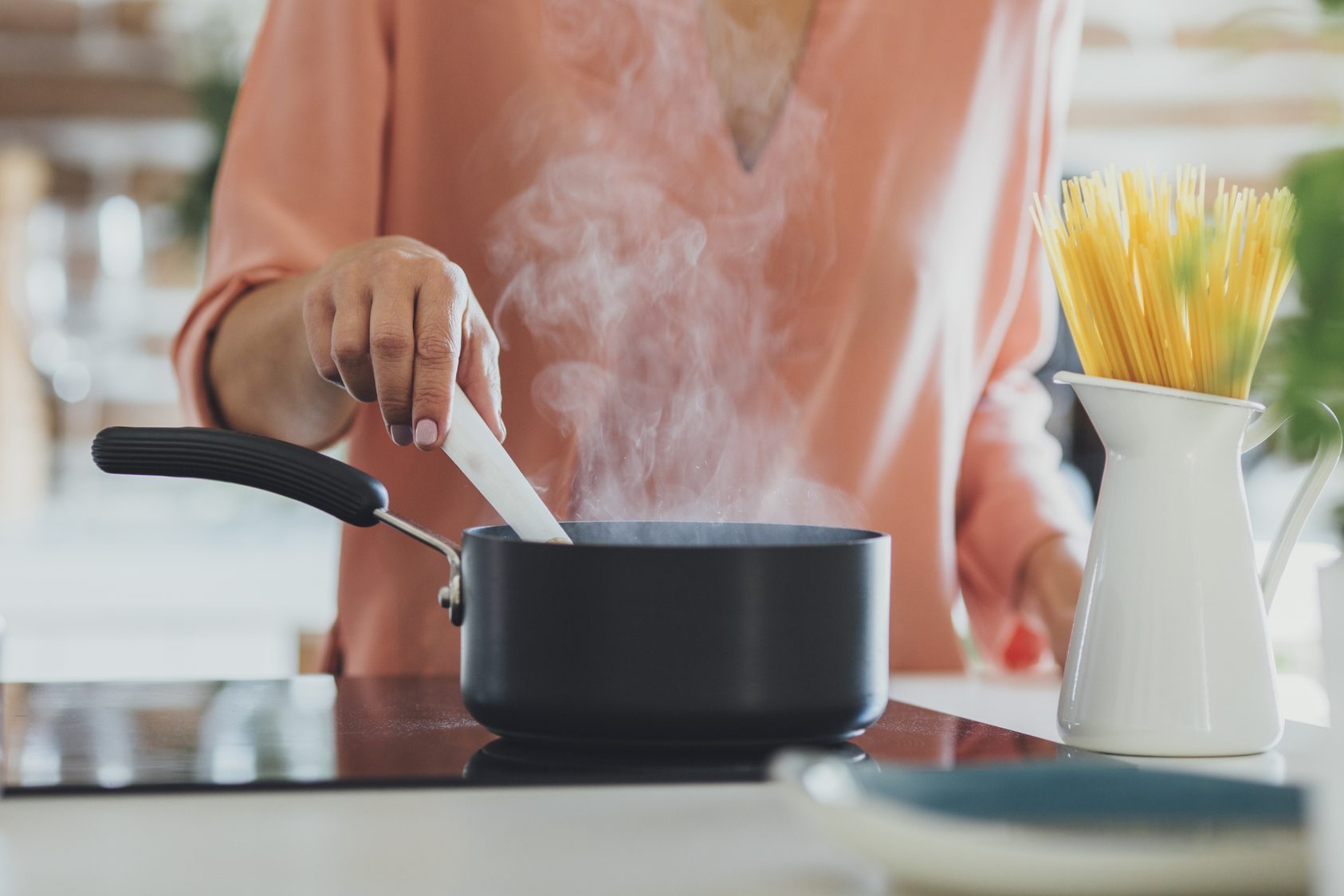 Older Caucasian woman cooking in kitchen