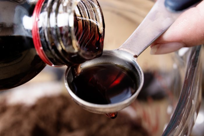 Close-up of medicine being poured onto a teaspoon