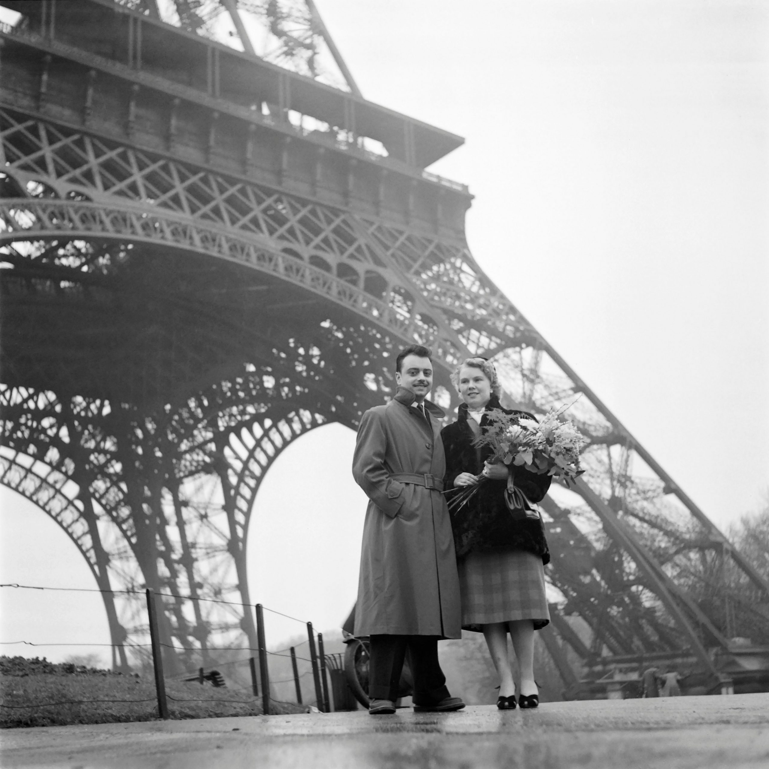 A couple of lovers pose in front of the Eiffel Tower in Paris during the Valentine
