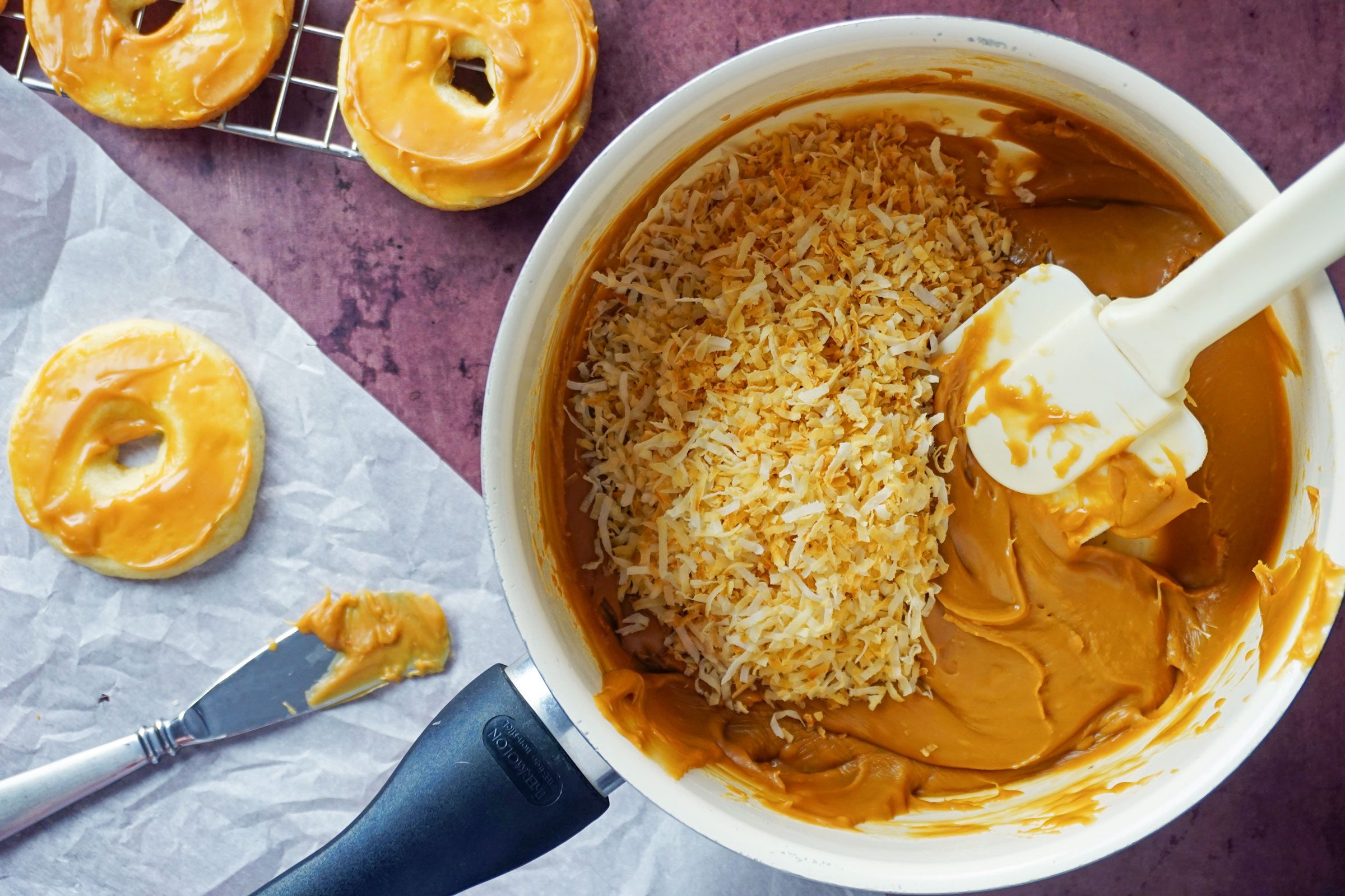mixing toasted coconut into melted caramel