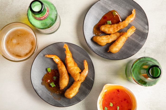tempura shrimp served on two plates with dipping sauce on the side