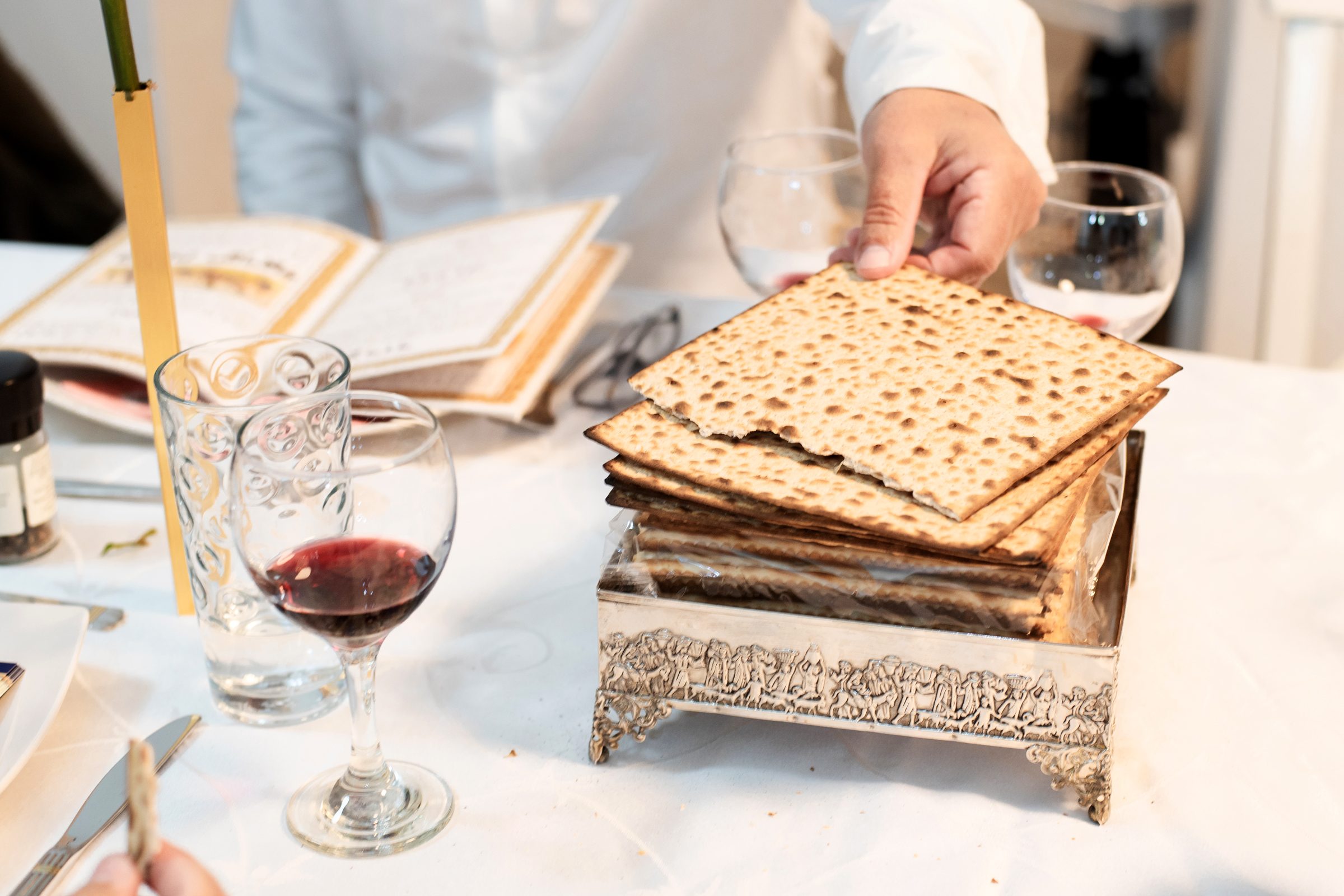 Man take and break off a piece matzo and read a book