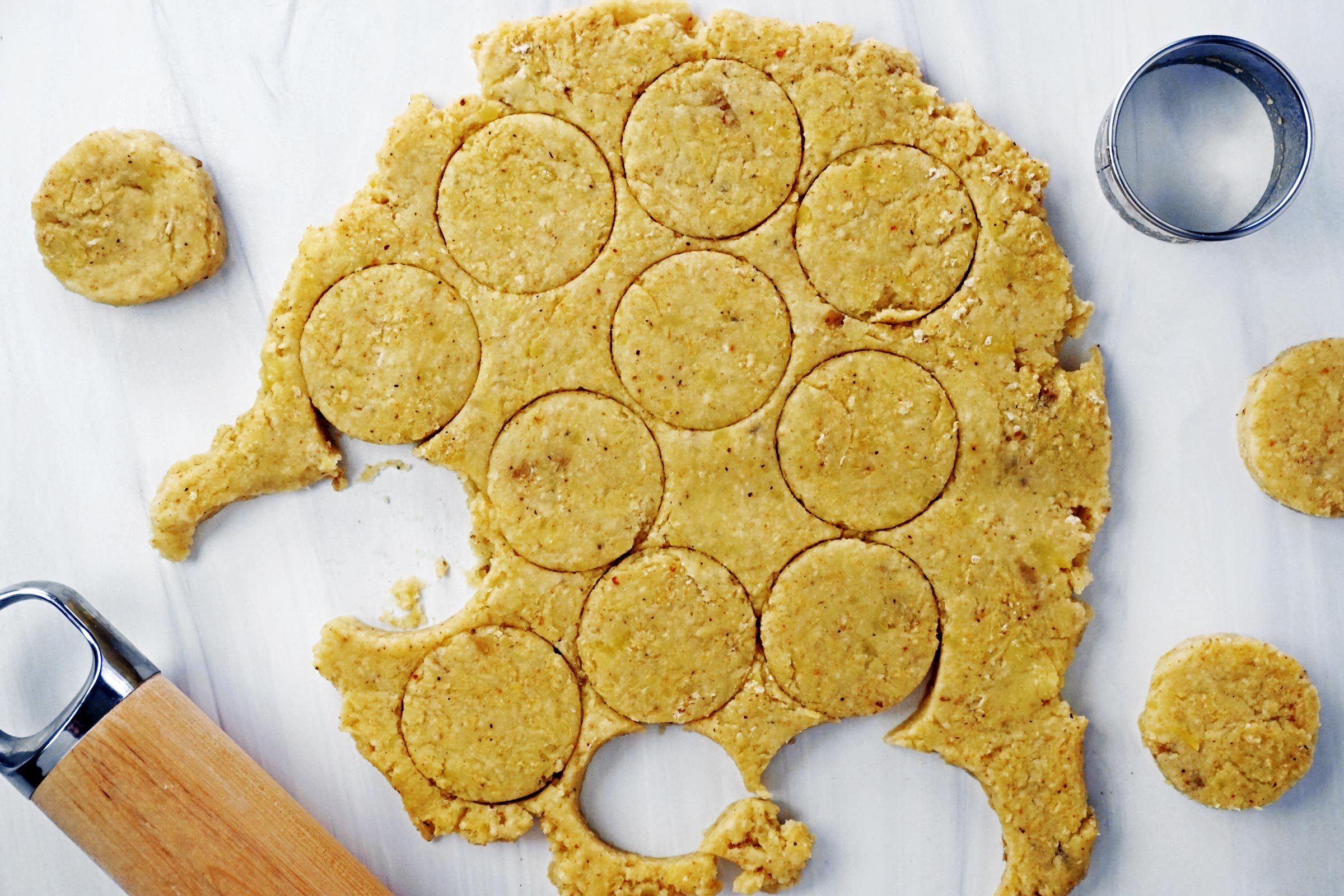 mashed potatoes rolled out in a thin layer and cut into small circles, view from above
