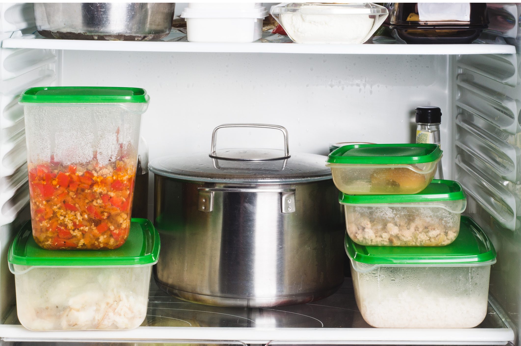 Refrigerator with different products in kitchen. Stocks of food for next mealtime