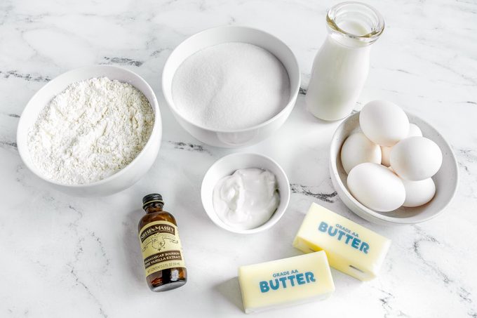 Cold Oven Pound Cake Ingredients layed out on a marble kitchen countertop