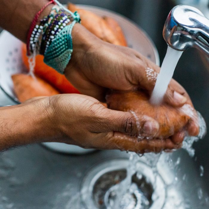Man Washing Sweet Potato