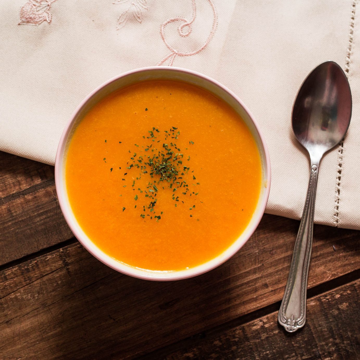 Pumpkin Cream With Chives And Parsley On Wooden Table