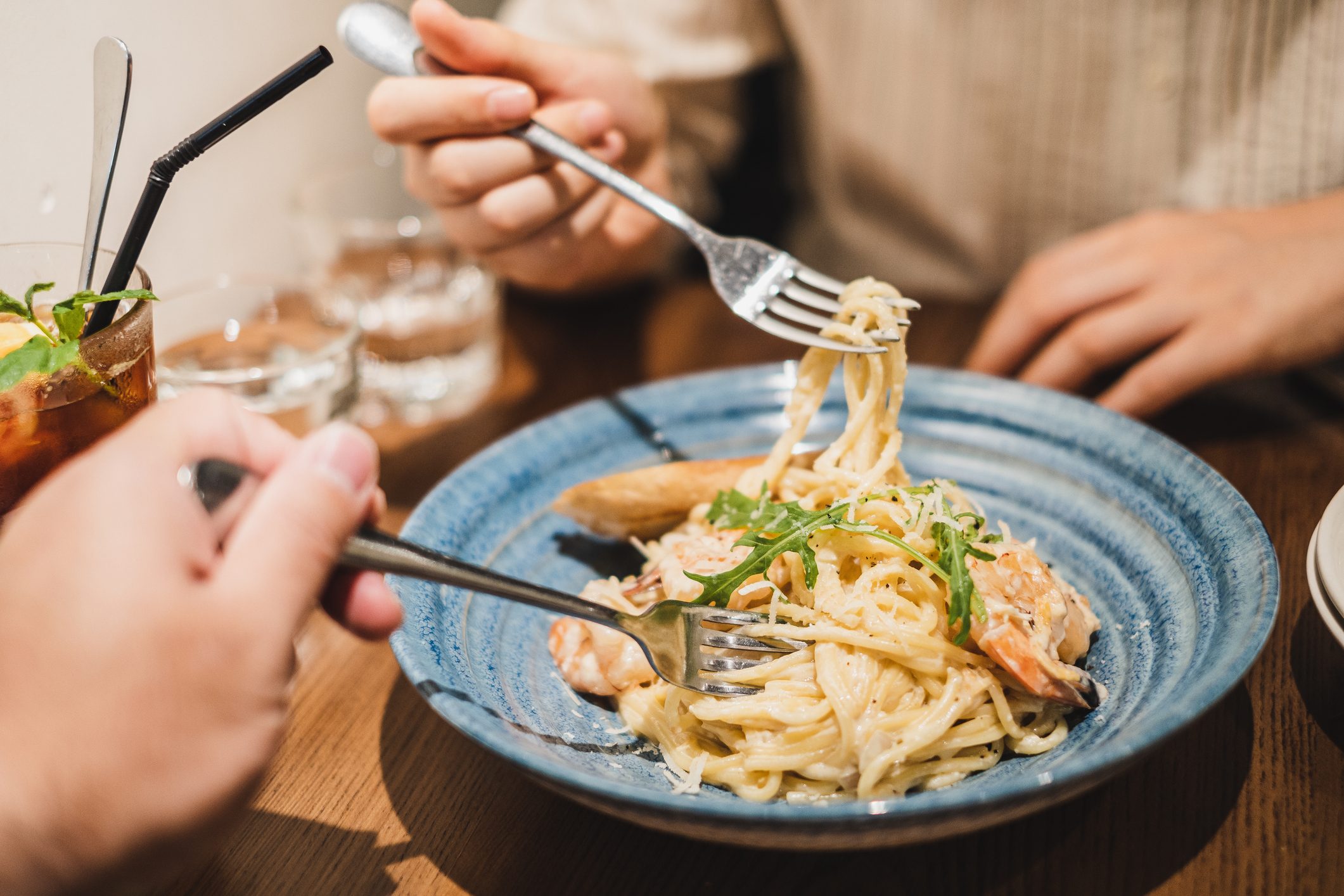 couple sharing spaghetti at a restaurant
