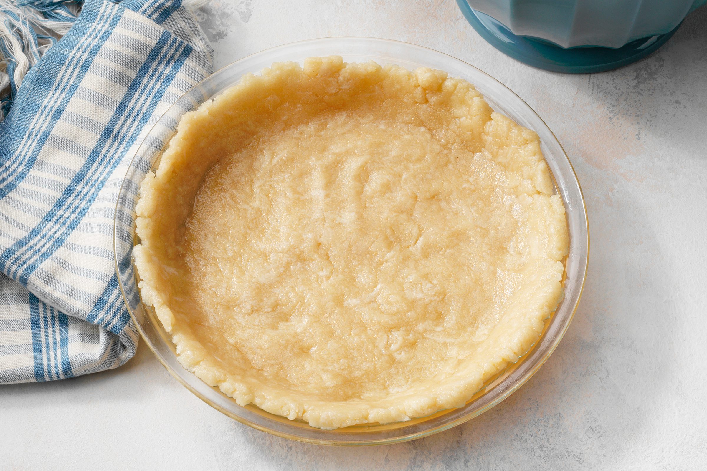 How To Make an Oil Pie Crust featuring Taste of Home's Easy No-Roll Pie Pastry recipe; step 3 of 4; Press dough into 9 inch pie plate